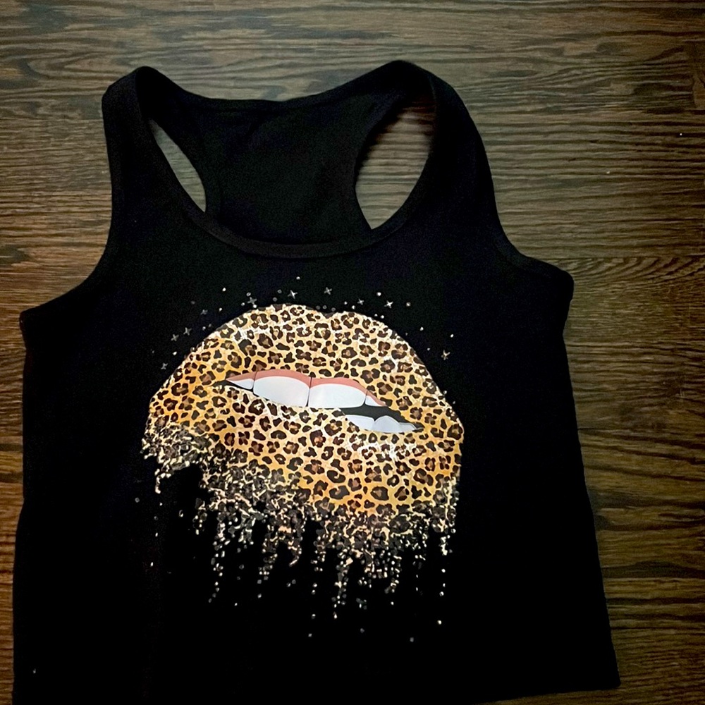 A black tank top with a cheetah print kiss. Let me know if you’re interested $25